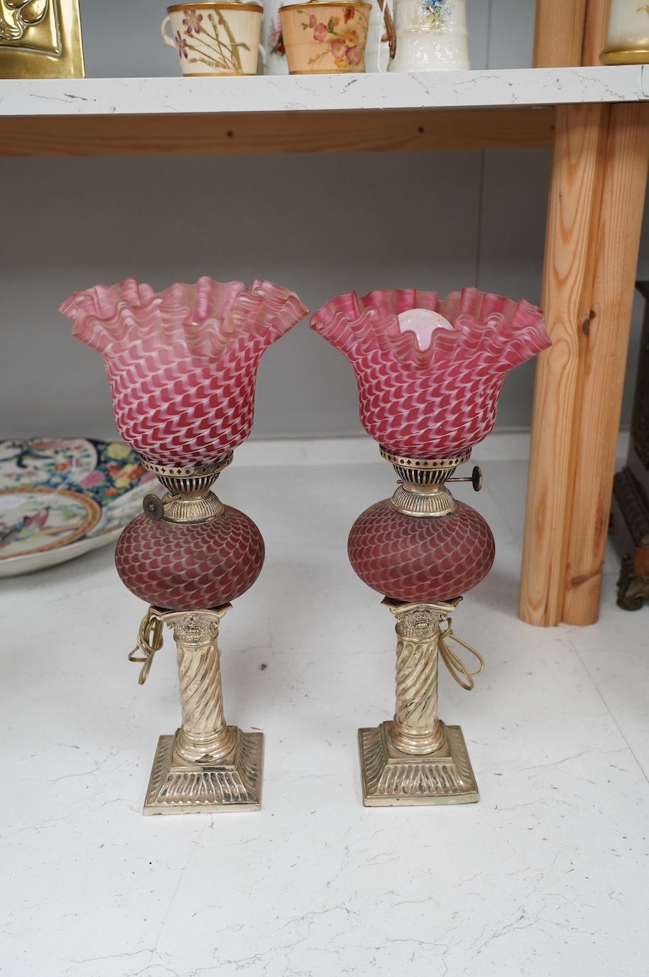 A pair of electroplate and ruby glass oil lamps, 35cm. Condition - good, not tested as working